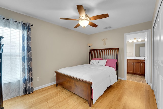 bedroom with light hardwood / wood-style floors, a closet, ceiling fan, and ensuite bathroom