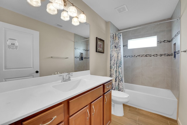 full bathroom featuring toilet, shower / bath combo with shower curtain, and vanity