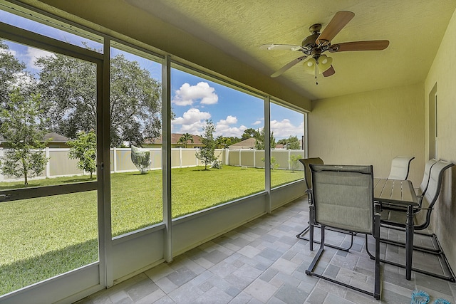 sunroom featuring ceiling fan