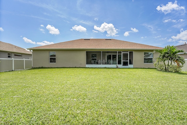 rear view of house with a yard