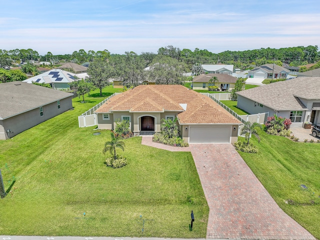 view of front of home featuring a front lawn and a garage