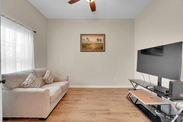 living room featuring ceiling fan and light hardwood / wood-style flooring