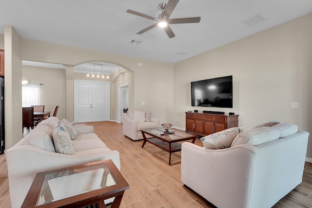 living room with ceiling fan and light hardwood / wood-style floors