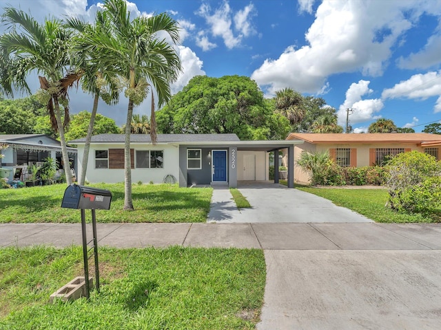 single story home featuring a carport and a front lawn