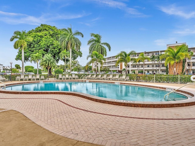 pool featuring a patio area and fence