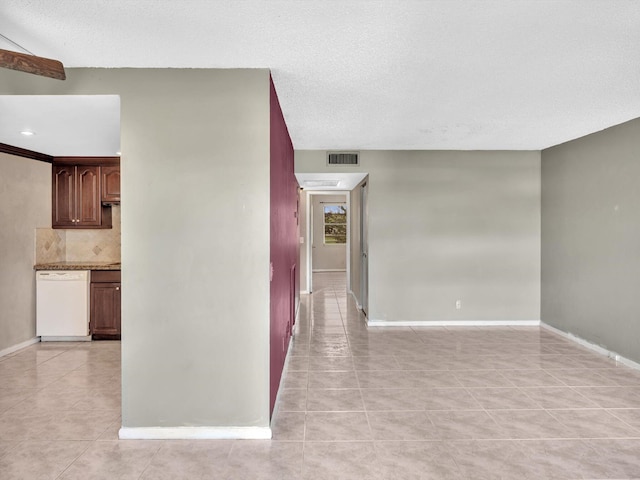 interior space with light tile patterned flooring and a textured ceiling