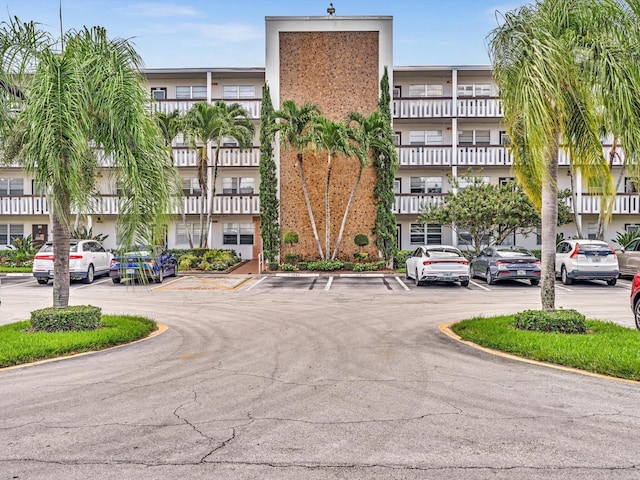 view of building exterior with uncovered parking