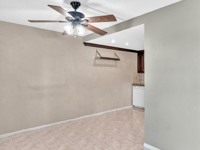 empty room featuring a ceiling fan, light tile patterned flooring, and baseboards