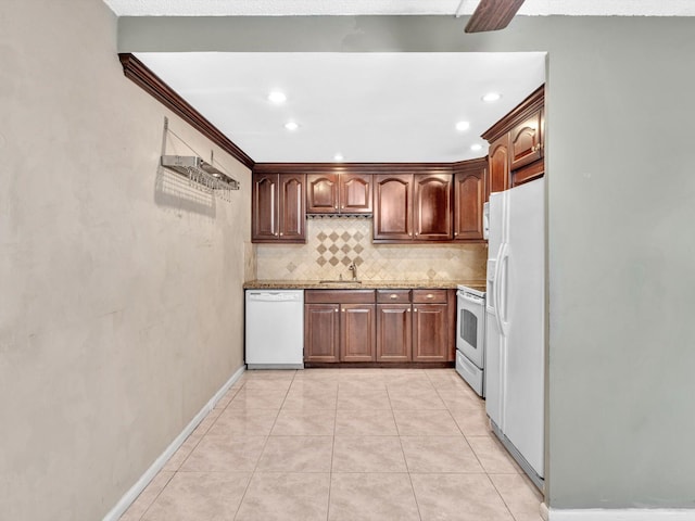 kitchen featuring sink, light stone countertops, white appliances, tasteful backsplash, and light tile patterned floors