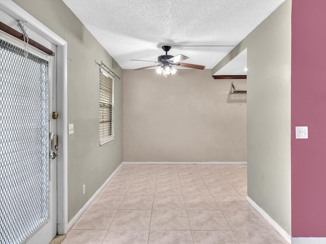 interior space featuring a textured ceiling and ceiling fan