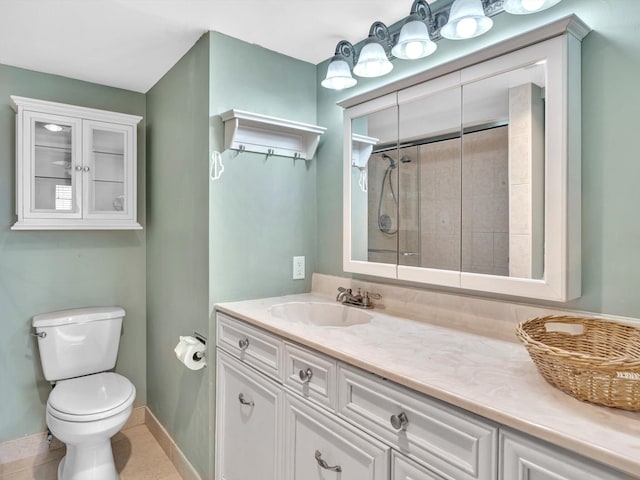 bathroom featuring a shower, tile patterned floors, vanity, and toilet