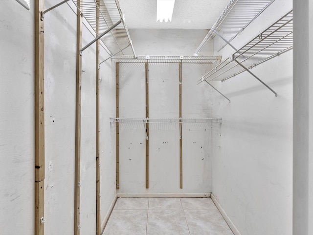 walk in closet featuring light tile patterned floors