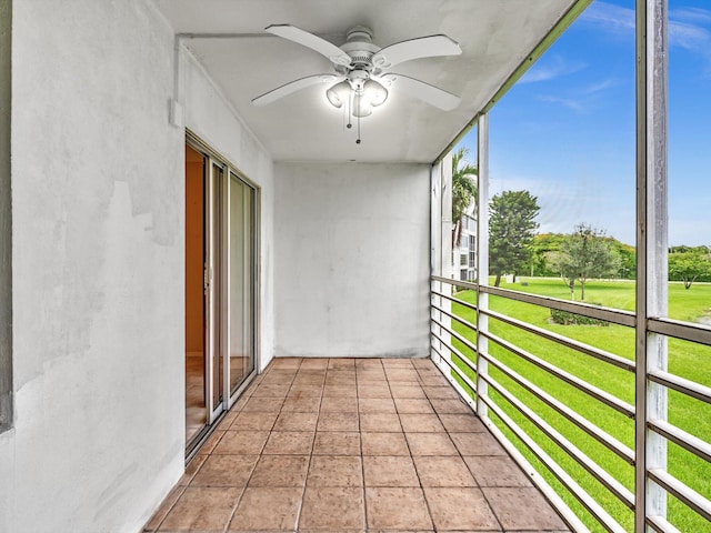 unfurnished sunroom with a ceiling fan