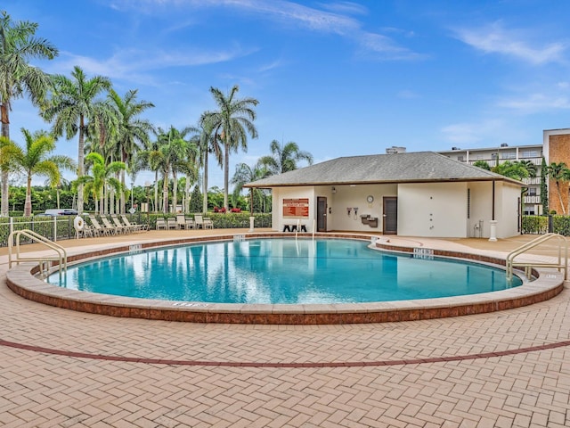 pool featuring fence and a patio