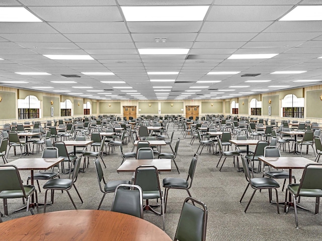 dining room featuring carpet floors and a paneled ceiling