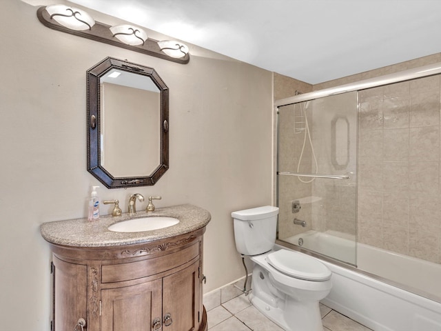 full bathroom with tile patterned flooring, toilet, bath / shower combo with glass door, vanity, and baseboards