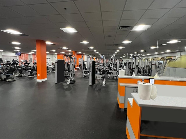 gym with a paneled ceiling