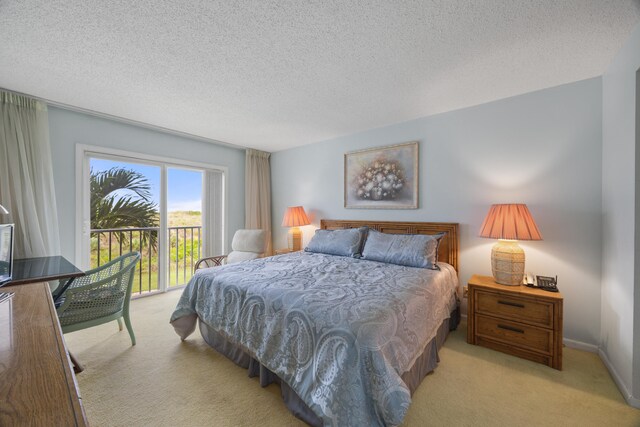 bedroom featuring a textured ceiling, light carpet, and access to exterior