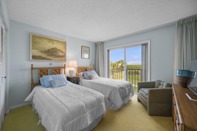 bedroom featuring light carpet, a textured ceiling, a closet, and access to exterior