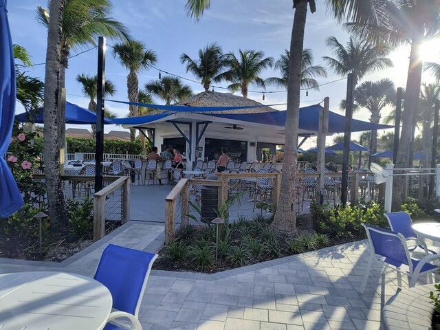 2400 S Ocean Dr Unit 124, Fort Pierce, FL 34949 - view of home's community with a patio area, fence, and outdoor dry bar