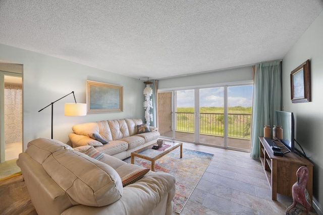 2400 S Ocean Dr Unit 124, Fort Pierce, FL 34949 - living room featuring a textured ceiling and stone finish flooring