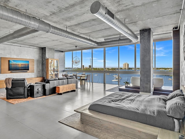 bedroom with expansive windows and a water view