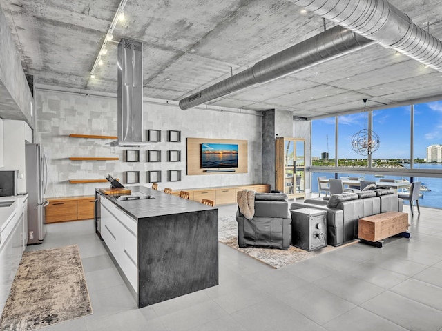 living area featuring a chandelier and a wall of windows