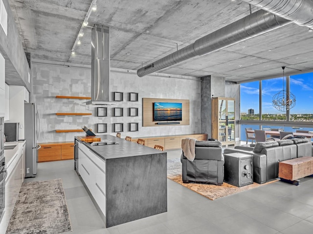 kitchen featuring white cabinets, a large island, modern cabinets, appliances with stainless steel finishes, and open floor plan