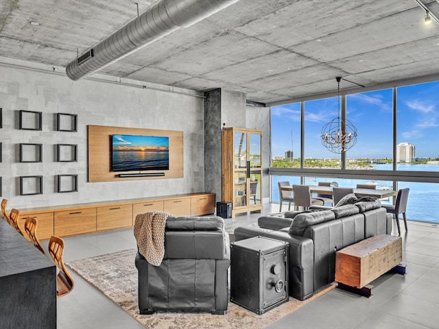 living area featuring a wall of windows and an inviting chandelier