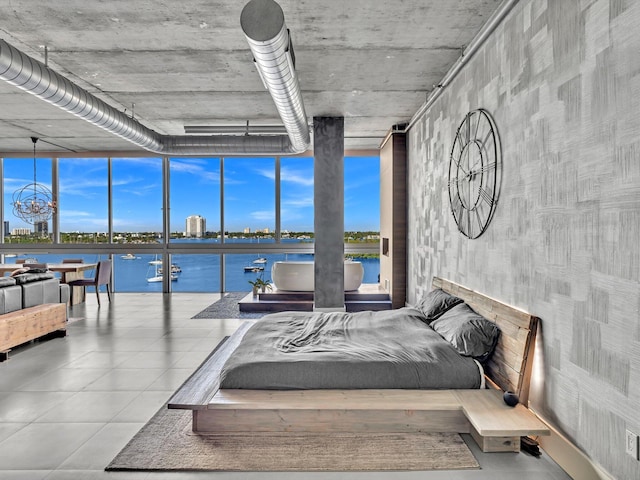 bedroom with expansive windows and a water view