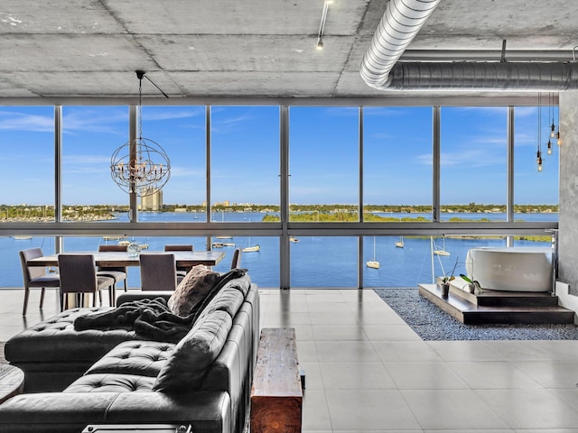 living area featuring a water view, floor to ceiling windows, and a notable chandelier