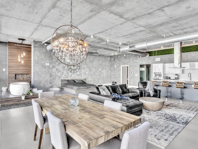 dining space featuring visible vents, a notable chandelier, and a fireplace