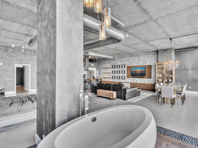 bathroom with a soaking tub and a notable chandelier