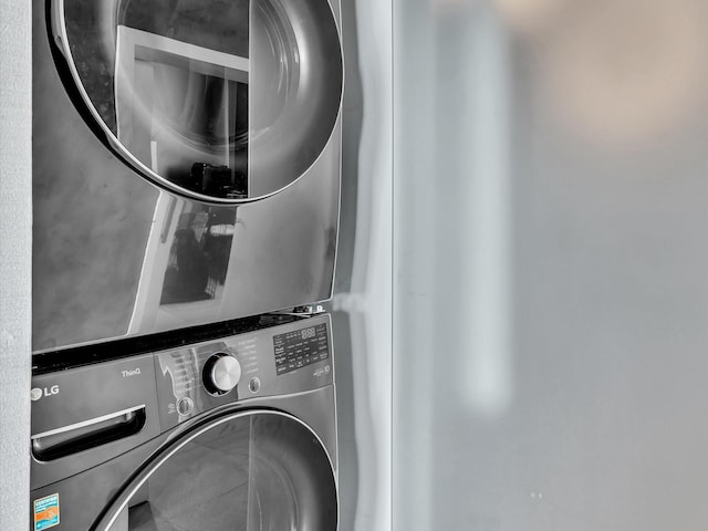 laundry room with laundry area and stacked washer / dryer