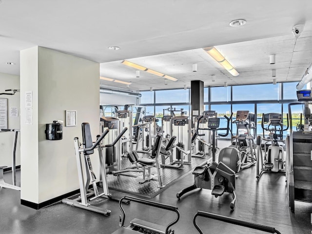 gym with baseboards and a wall of windows