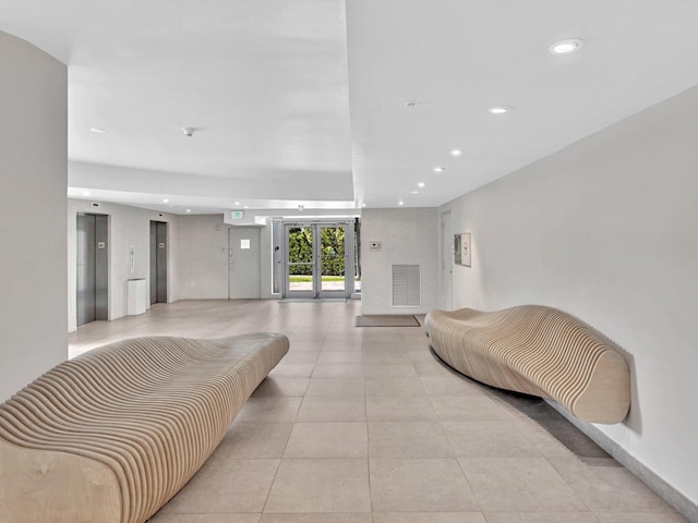 bedroom featuring recessed lighting, elevator, visible vents, and light tile patterned floors