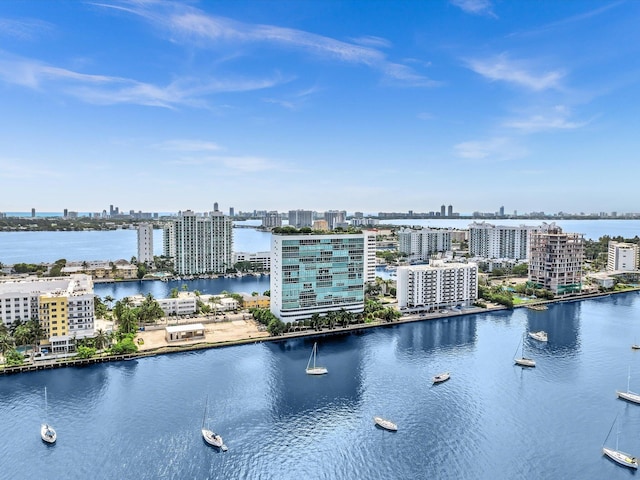 birds eye view of property with a water view and a view of city