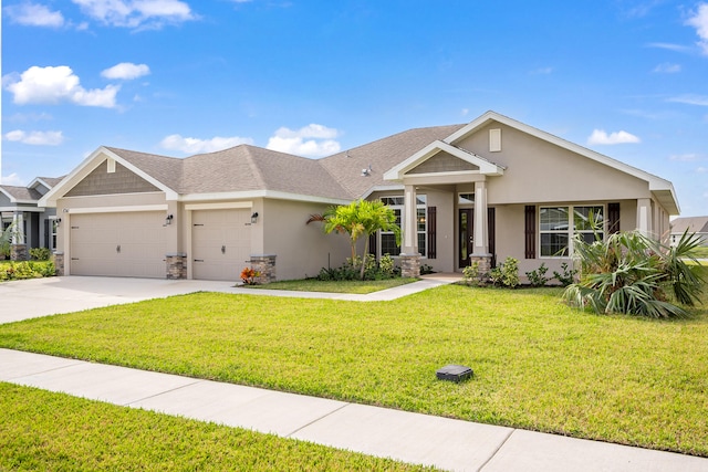 craftsman-style house featuring a front yard and a garage