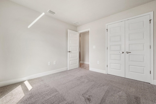 unfurnished bedroom with carpet floors and a closet