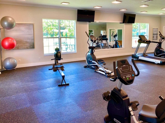 gym with crown molding and a textured ceiling