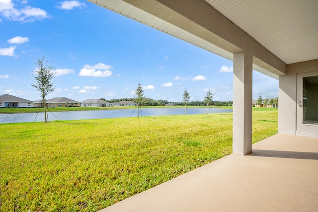 view of yard featuring a water view and a patio area