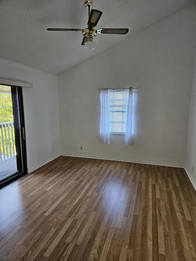 spare room with a ceiling fan, lofted ceiling, baseboards, and wood finished floors