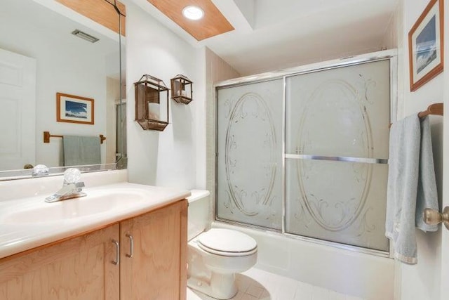 bathroom featuring toilet, shower / bath combination with glass door, vanity, visible vents, and tile patterned floors