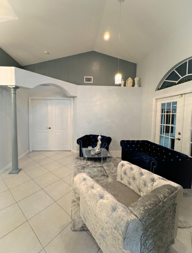 living room featuring ornate columns, light tile patterned floors, and lofted ceiling