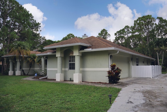 view of front of home with a front lawn and a garage