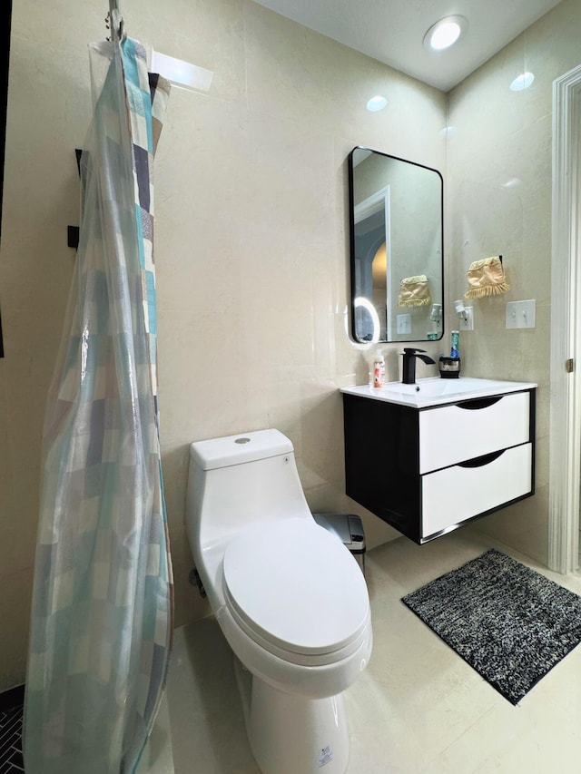 bathroom featuring toilet, tile patterned floors, and vanity