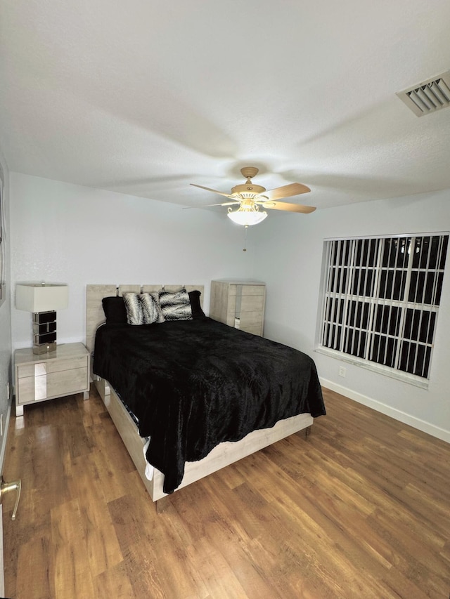 bedroom featuring ceiling fan and hardwood / wood-style flooring