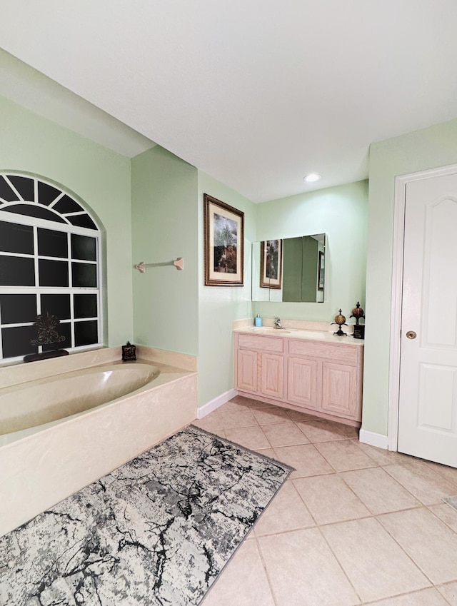 bathroom featuring a tub, vanity, and tile patterned floors