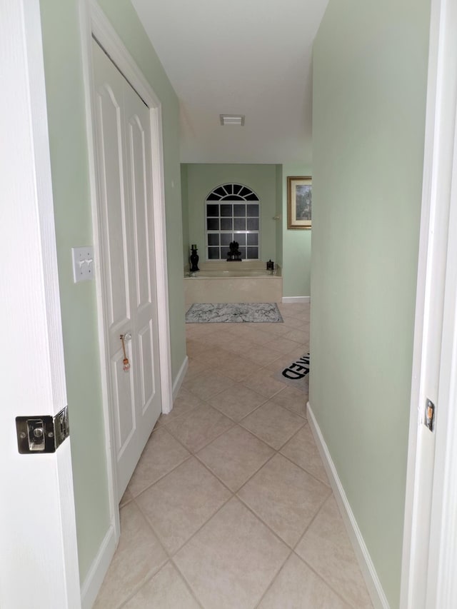 hall with light tile patterned flooring