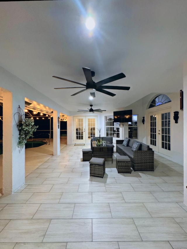 living room featuring light tile patterned flooring, french doors, and ceiling fan